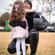 Imagem mostra policial emocionado abraçando a filha em um gramado