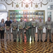 Foto mostra a comissão de elaboração do livro ladeada pelo Comandante-Geral da BM e o Chefe do Estado-Maior da BM