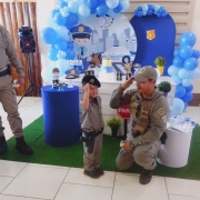 Benício Miguel, um pequeno admirador da Brigada Militar, presta continência ao lado de um policial militar durante sua festa de 4 anos.